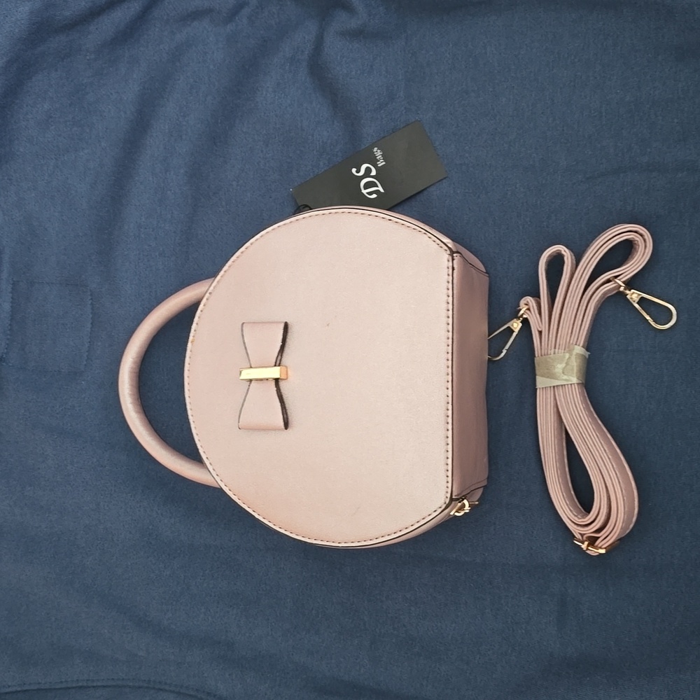 Pale pink metallic round handbag